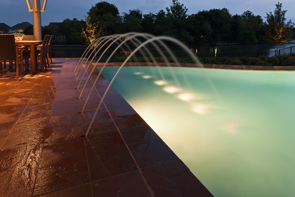 Pool fountain - mid-sized traditional backyard stone and custom-shaped pool fountain idea in Houston