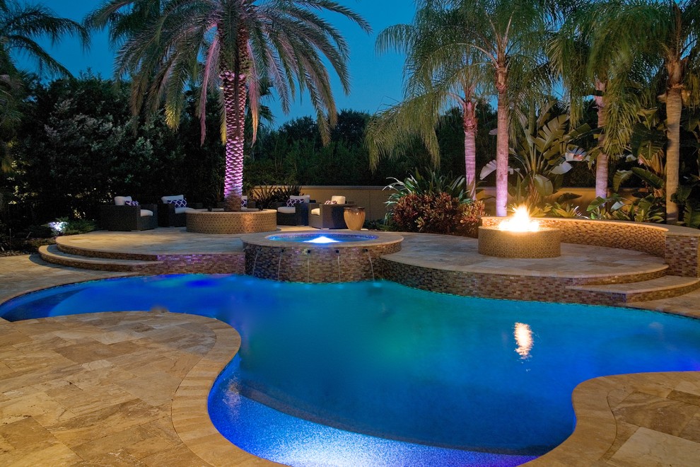 Idee per una grande piscina mediterranea personalizzata dietro casa con fontane e pavimentazioni in pietra naturale