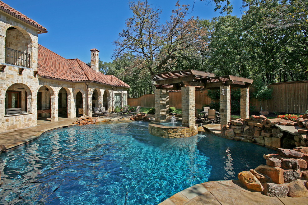 This is an example of a medium sized mediterranean back custom shaped natural hot tub in Dallas with stamped concrete.