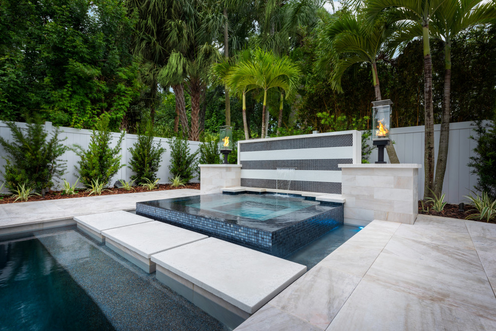 Mittelgroßer, Gefliester Moderner Infinity-Pool hinter dem Haus in rechteckiger Form mit Pool-Gartenbau in Tampa