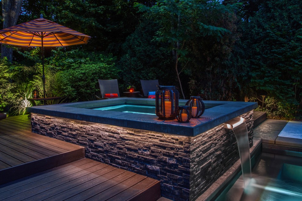 Large minimalist backyard tile and rectangular hot tub photo