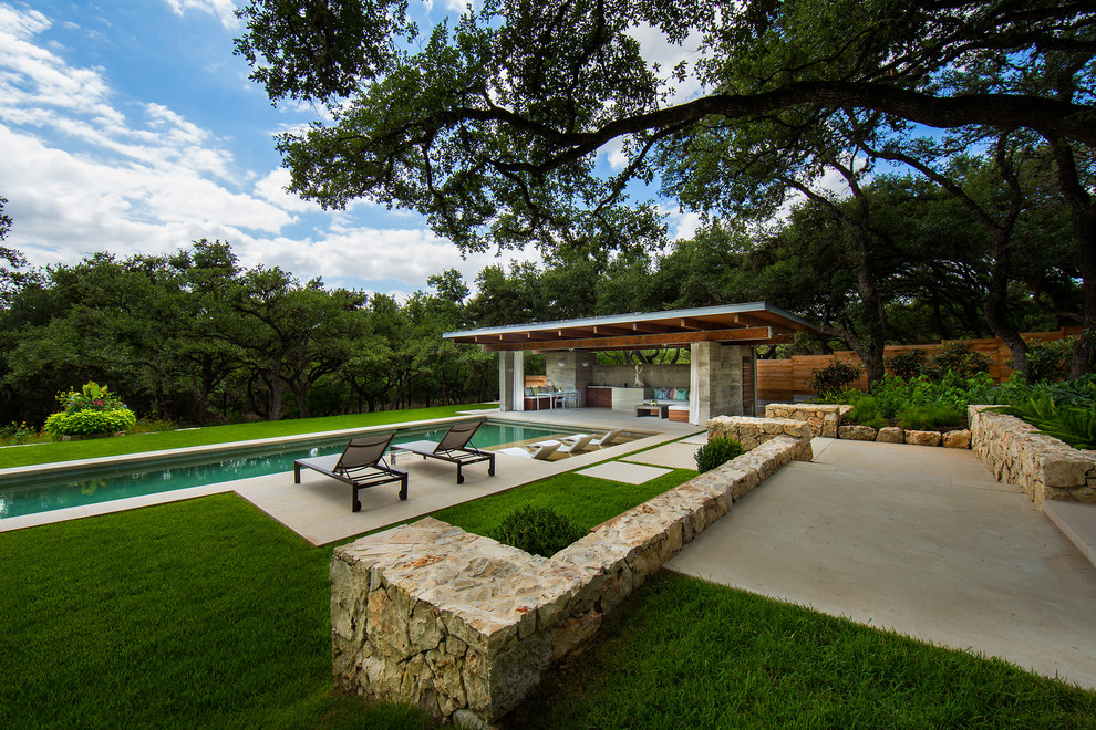 Inspiration for a large modern backyard stone and rectangular lap pool house remodel in Austin