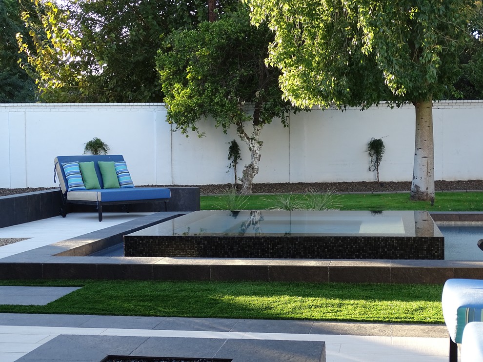 Inspiration for a large modern backyard tile and rectangular lap hot tub remodel in Phoenix