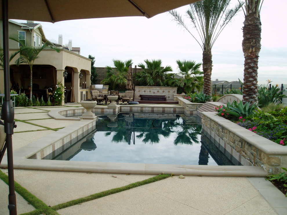 Pool - large mediterranean backyard concrete and custom-shaped natural pool idea in San Diego