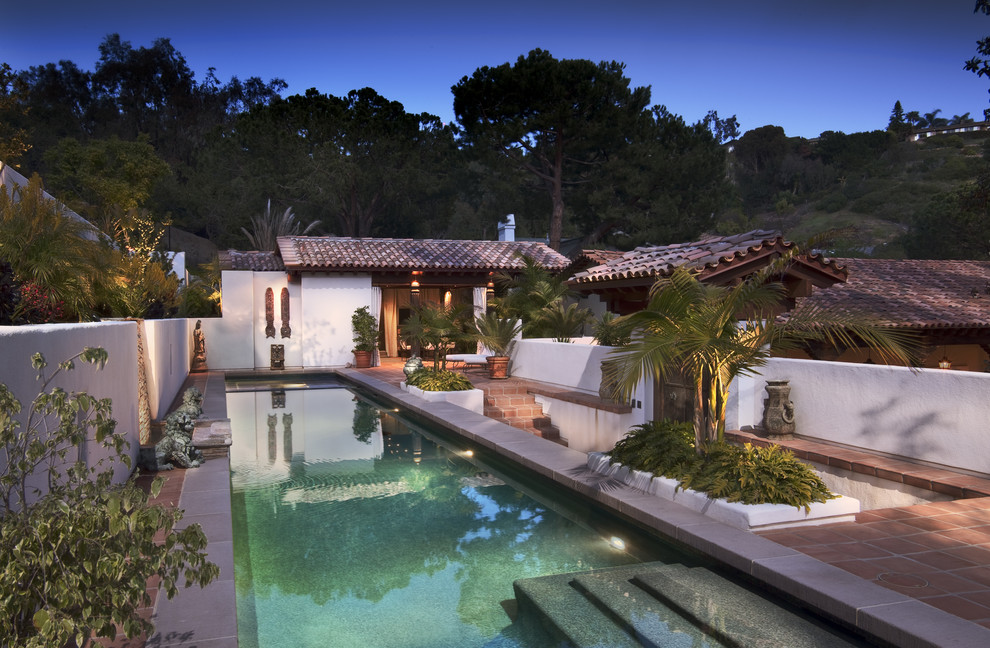 Large tuscan backyard tile and rectangular lap pool fountain photo in San Diego