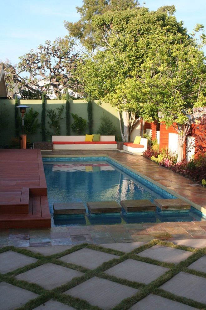 Example of a mid-sized minimalist backyard stone and rectangular lap pool design in Los Angeles