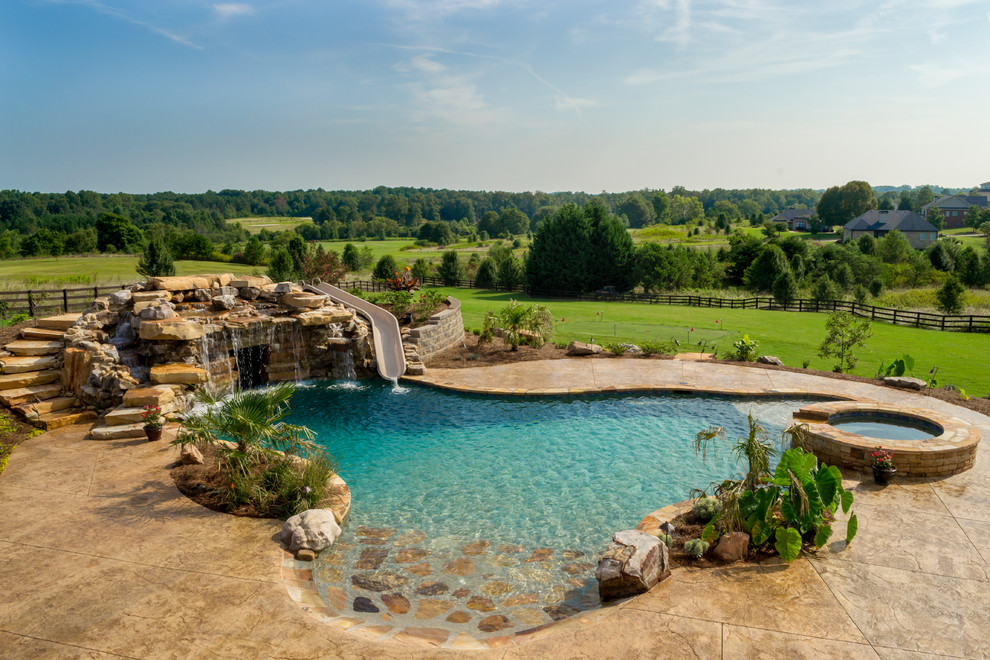 Inspiration for a huge rustic backyard stamped concrete and custom-shaped natural water slide remodel in Atlanta