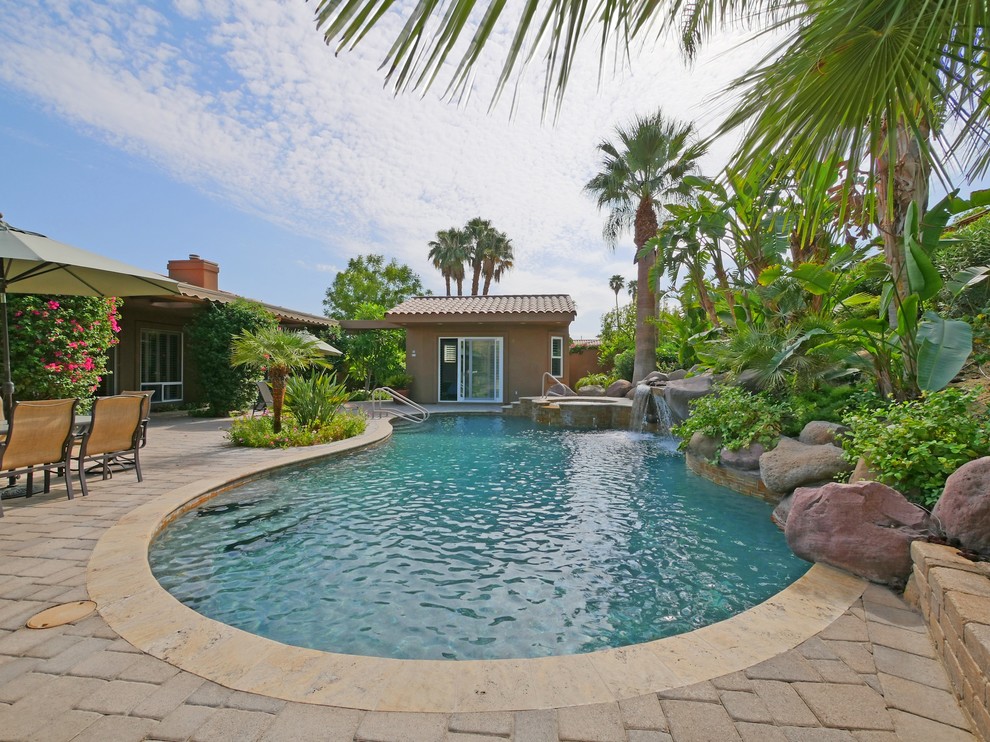 This is an example of a mediterranean back custom shaped swimming pool in Los Angeles.