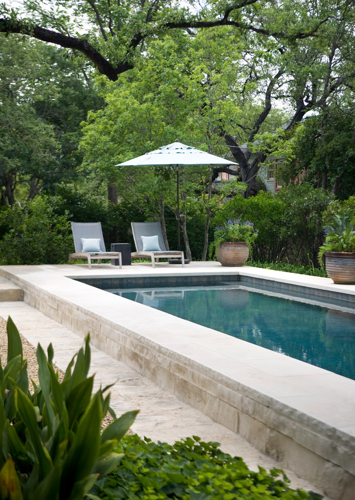 Pool house - large traditional backyard rectangular and stone lap pool house idea in Austin