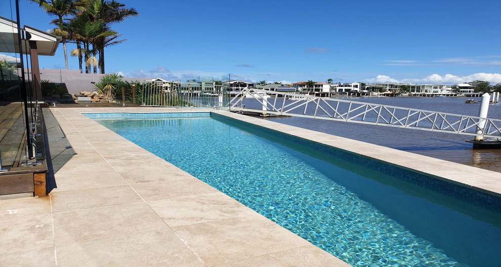 Example of a large minimalist backyard custom-shaped natural pool design in Sunshine Coast