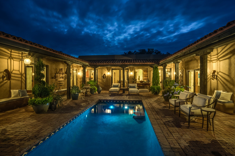 Inspiration for a medium sized mediterranean back rectangular lengths swimming pool in Albuquerque with brick paving.
