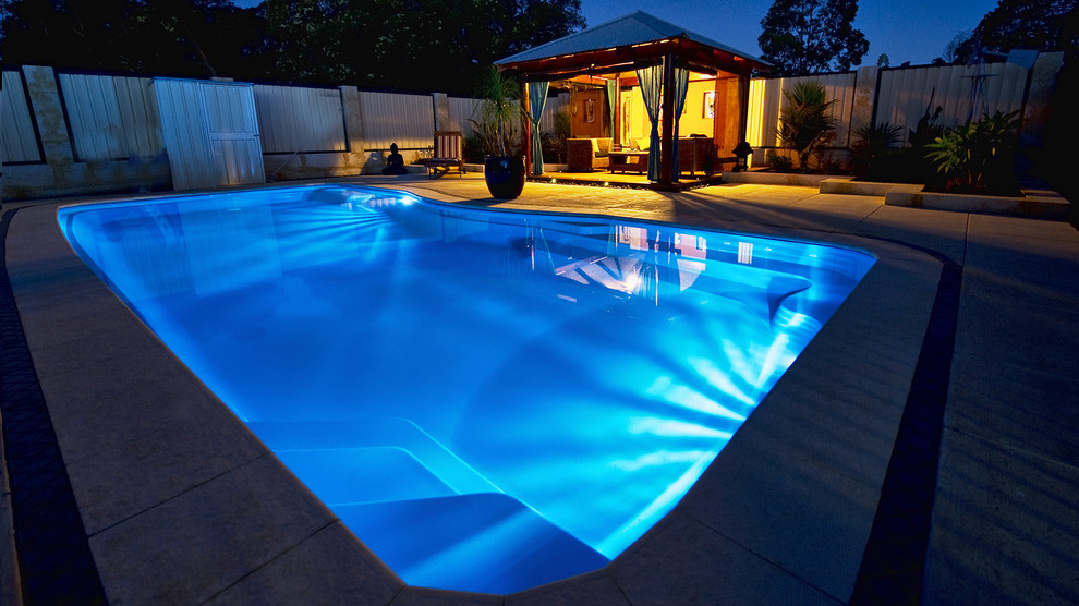 Inspiration for a large mediterranean back rectangular swimming pool in New York with a pool house and concrete paving.