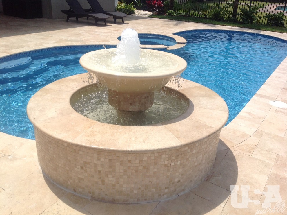 Inspiration for a large rustic above ground swimming pool in Miami with natural stone paving.