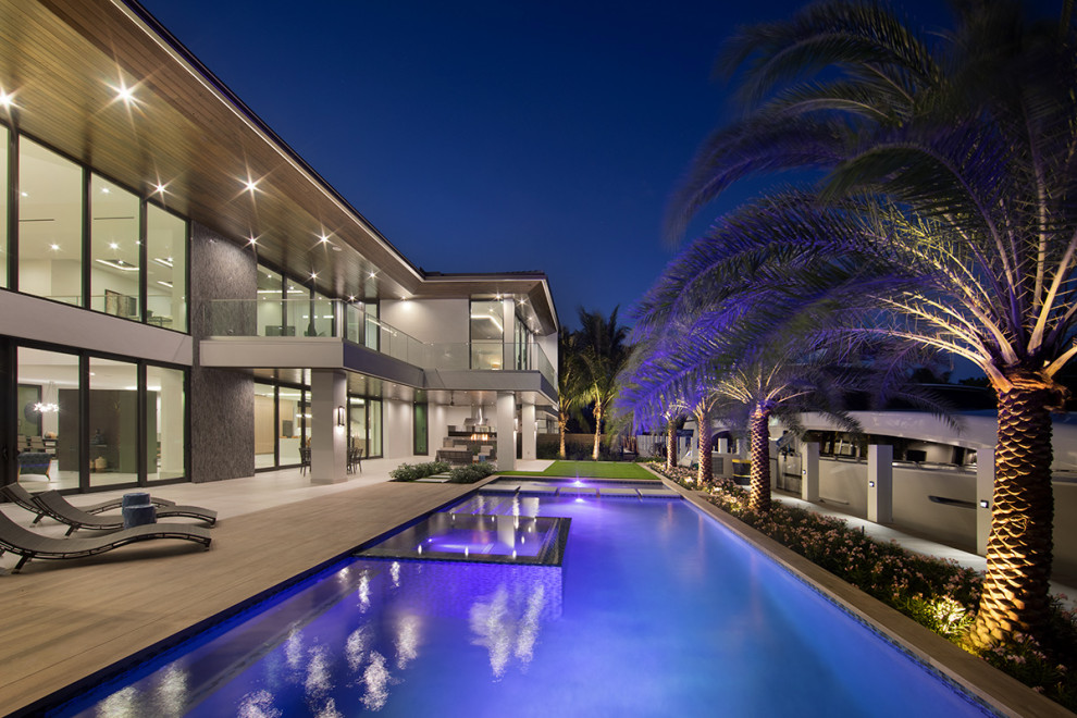 Example of a huge minimalist backyard rectangular lap hot tub design in Miami