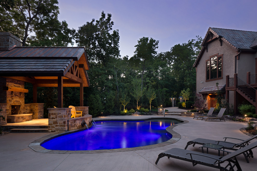 Example of a large mountain style backyard concrete and custom-shaped pool fountain design in Kansas City