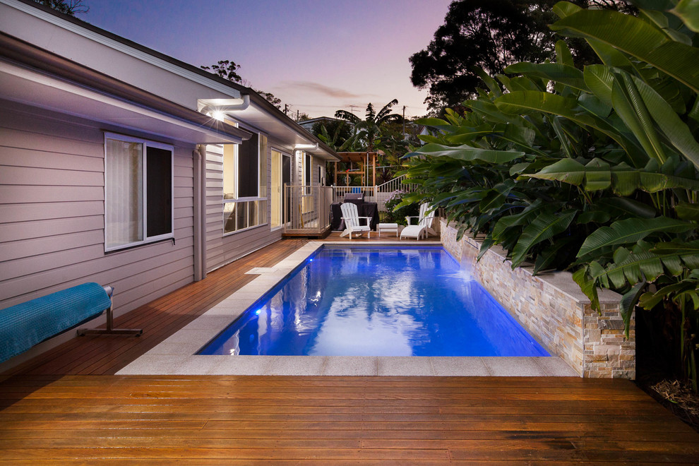 Immagine di una piscina monocorsia minimalista rettangolare di medie dimensioni e nel cortile laterale con pedane