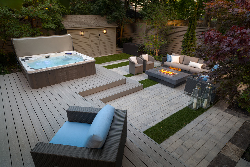Modern back hot tub in Toronto with a shelter and decking.