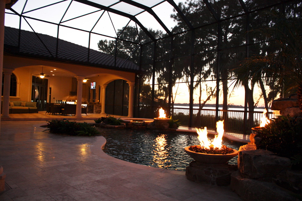 Mid-sized tuscan backyard stone and custom-shaped natural pool fountain photo in Tampa