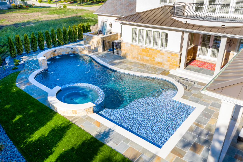 Naperville, IL freeform swimming pool with hot tub, large sunshelf