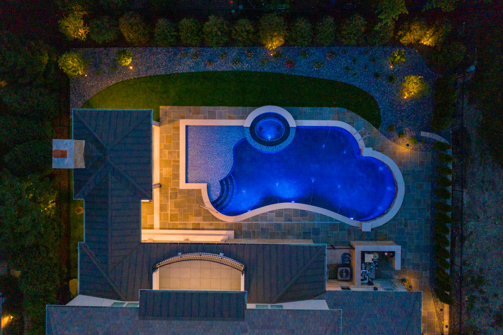 Mid-sized minimalist backyard stone and custom-shaped natural pool landscaping photo in Chicago