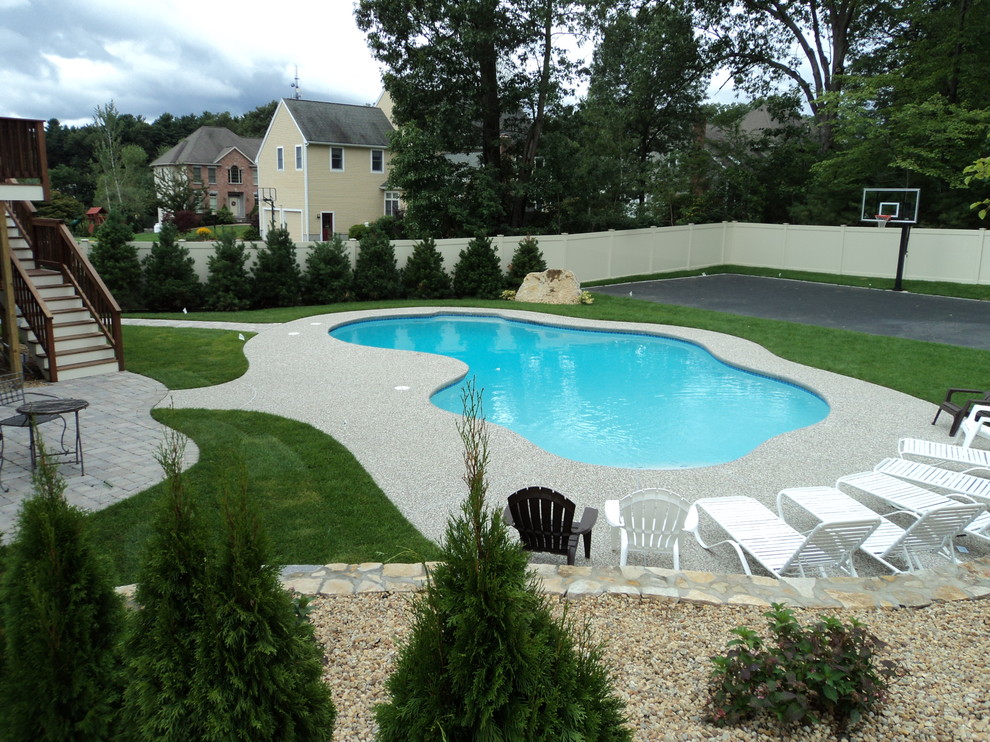 Foto de piscina natural vintage extra grande a medida en patio trasero con losas de hormigón