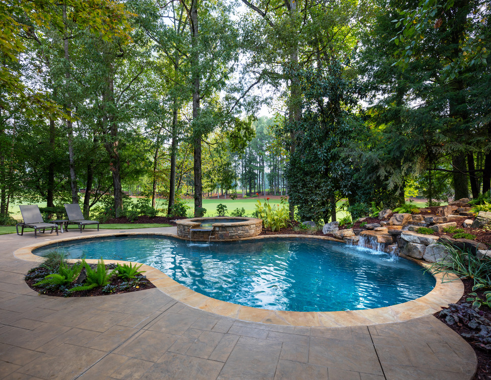 Inspiration for a mid-sized timeless backyard stone and custom-shaped natural hot tub remodel in Atlanta
