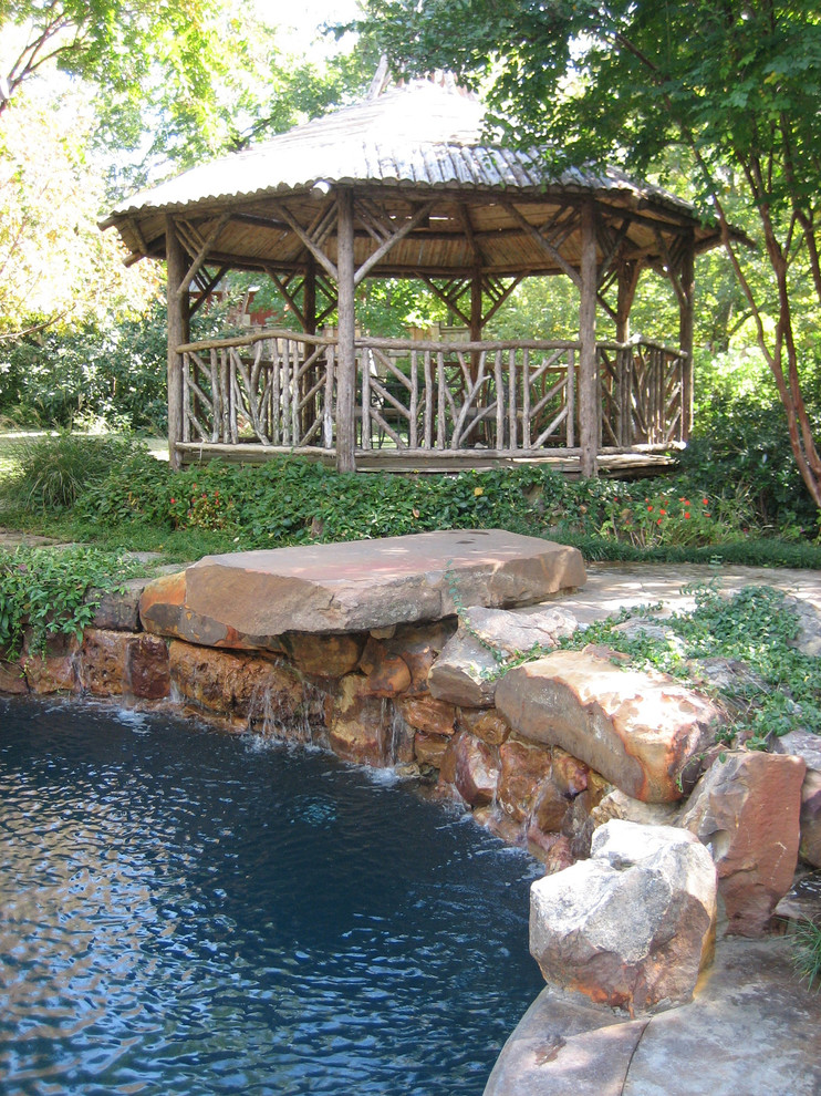 Inspiration for an eclectic round natural pool remodel in Dallas