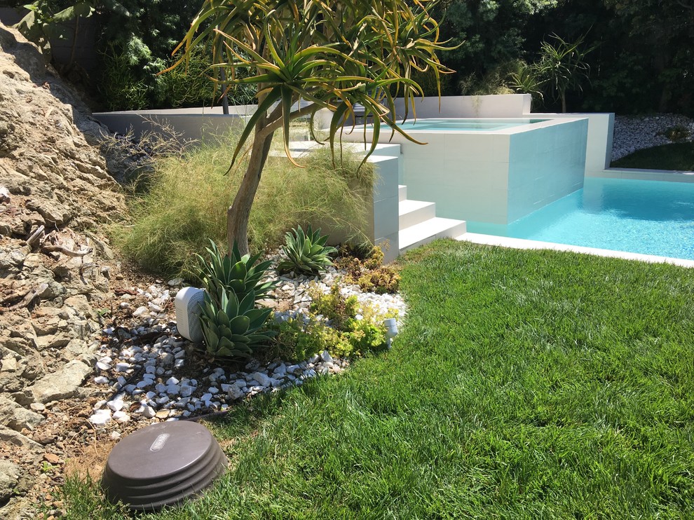 Réalisation d'une piscine hors-sol et arrière design de taille moyenne et rectangle avec un bain bouillonnant.