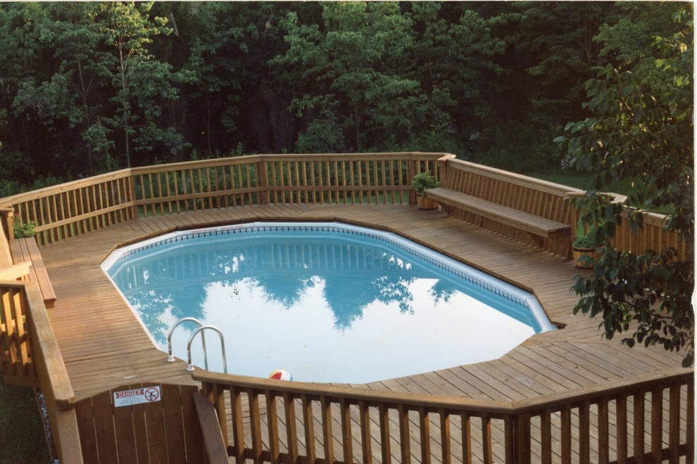 Example of a large classic backyard custom-shaped and gravel aboveground pool design in Newark