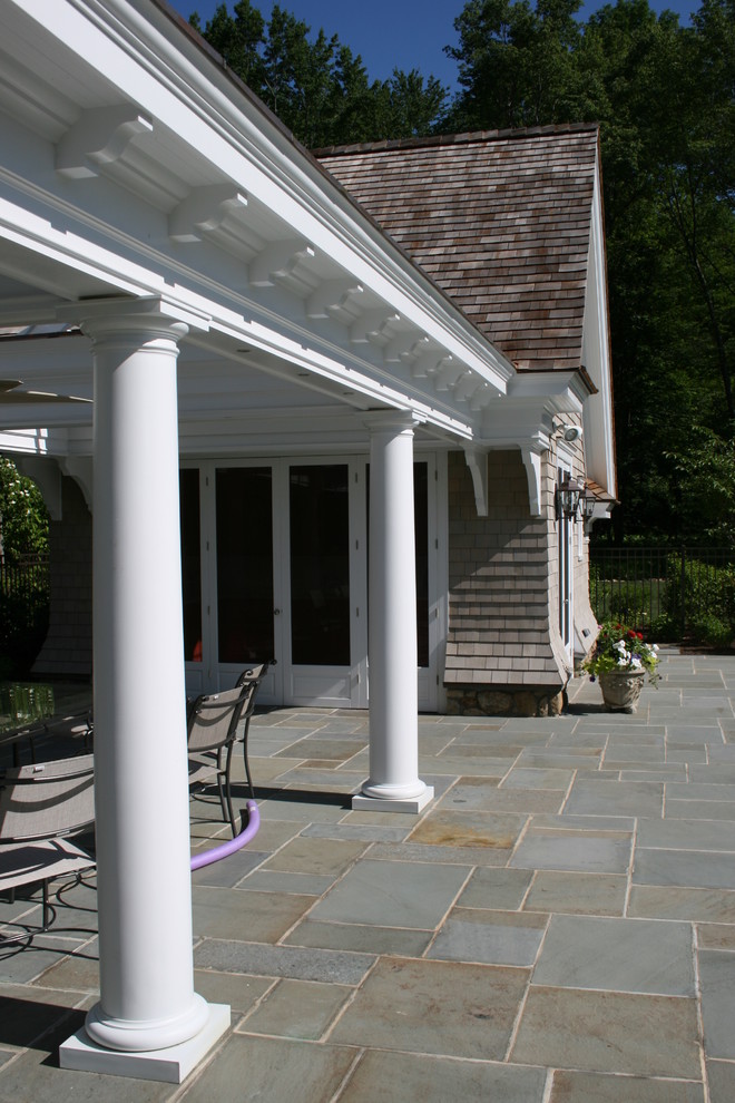 Example of a large ornate backyard stamped concrete and rectangular lap pool house design in New York