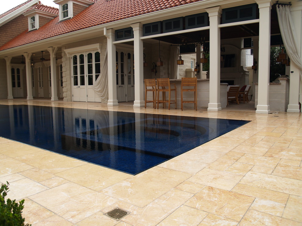 Photo of a medium sized mediterranean back custom shaped lengths swimming pool in New Orleans with natural stone paving and a pool house.