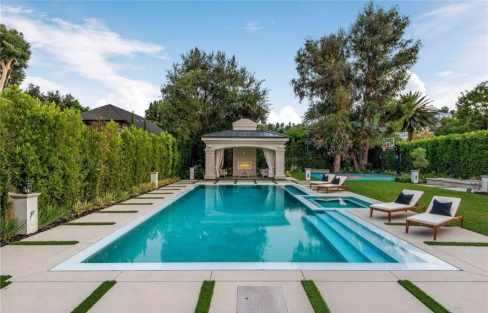 Inspiration for a large transitional backyard concrete paver and rectangular lap pool remodel in Los Angeles