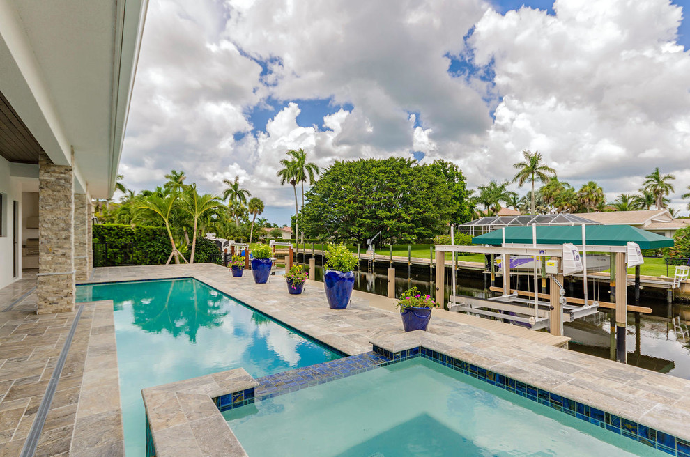 Pool - large transitional backyard tile and rectangular natural pool idea in Miami