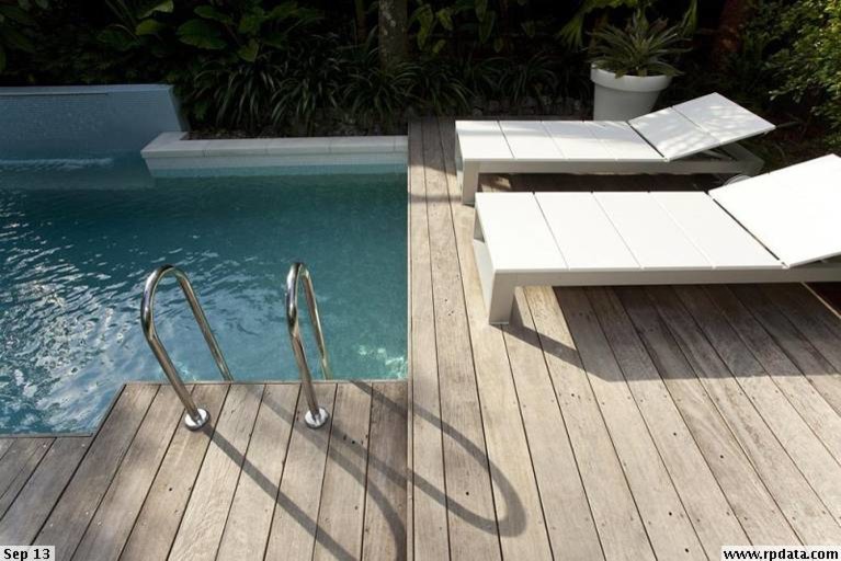 Inspiration for a small contemporary back rectangular lengths swimming pool in Brisbane with a water feature and decking.