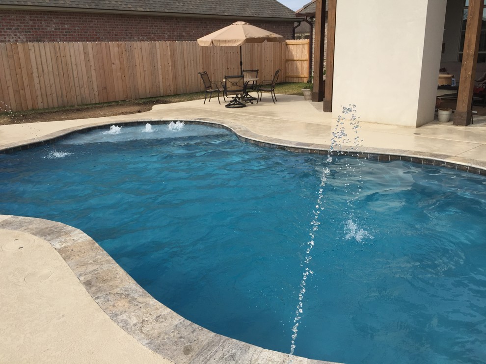Mid-sized trendy backyard custom-shaped pool fountain photo in New Orleans with decking