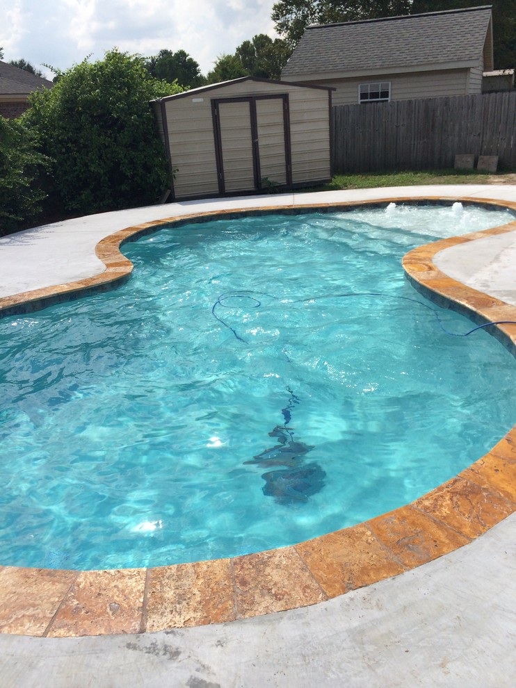 Pool fountain - small modern backyard concrete and custom-shaped natural pool fountain idea in New Orleans