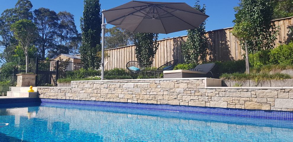 Design ideas for a medium sized contemporary back rectangular lengths swimming pool in Sunshine Coast with concrete paving.
