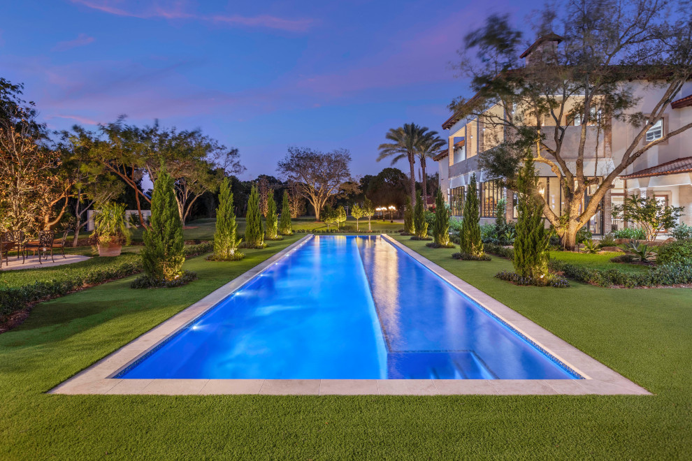 Photo of an expansive modern back rectangular infinity swimming pool in Miami.