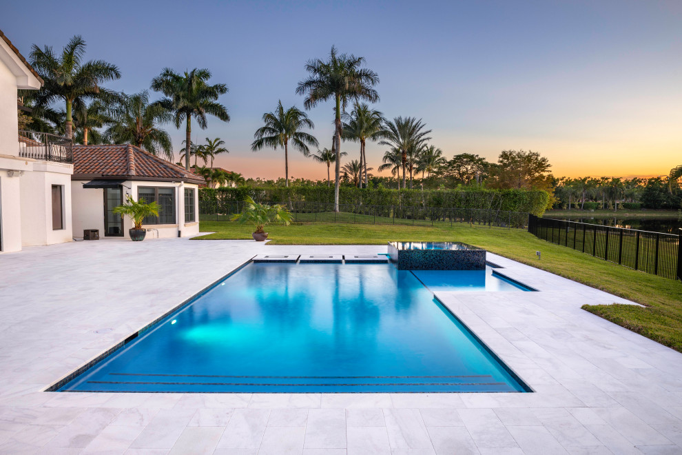 Esempio di una piscina monocorsia minimalista rettangolare di medie dimensioni e dietro casa con una vasca idromassaggio