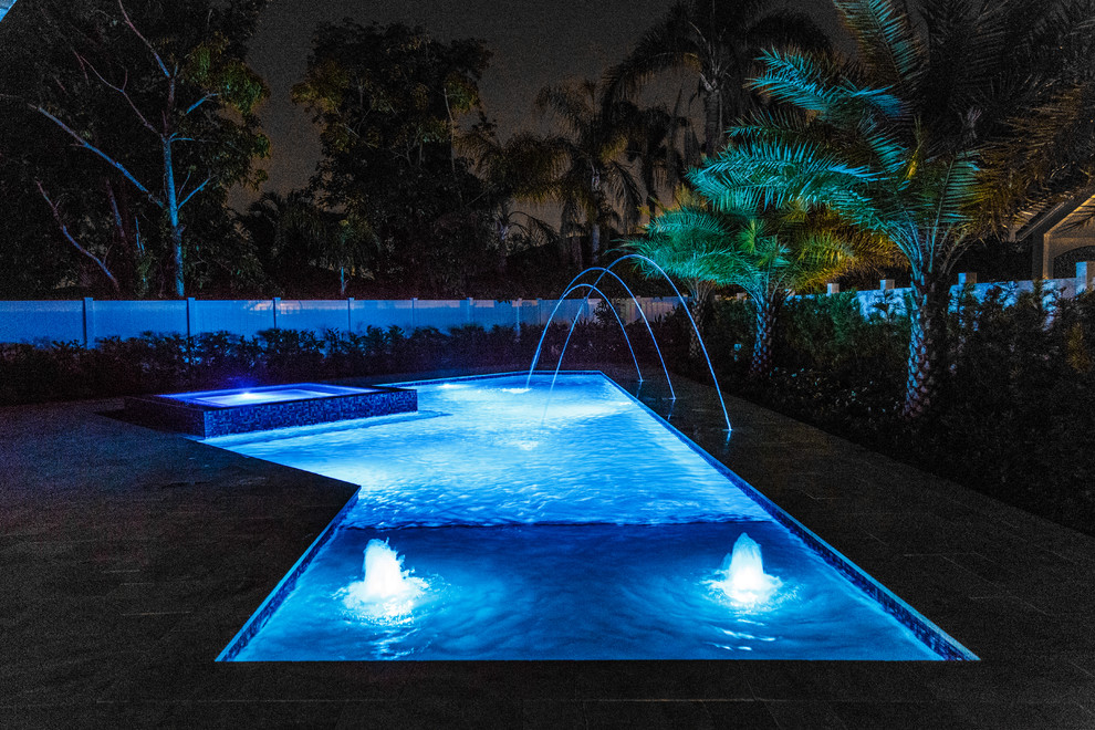 Example of a large trendy backyard custom-shaped and tile hot tub design in Miami