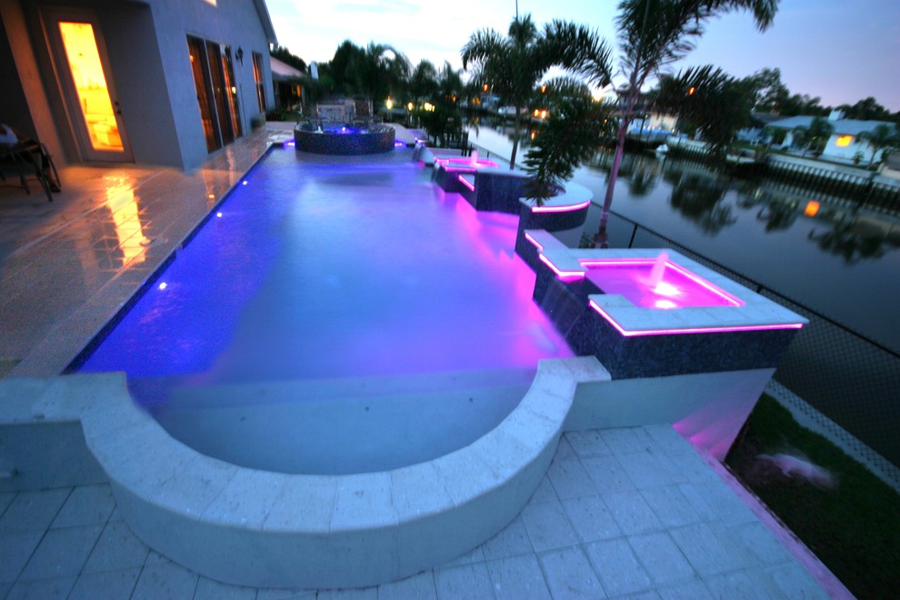 Inspiration for a large traditional back rectangular lengths hot tub in Tampa with concrete paving.