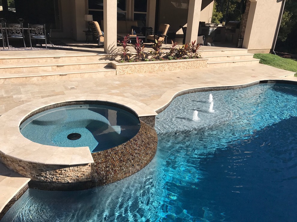 Источник вдохновения для домашнего уюта: большой бассейн произвольной формы на заднем дворе в стиле неоклассика (современная классика) с джакузи и покрытием из плитки