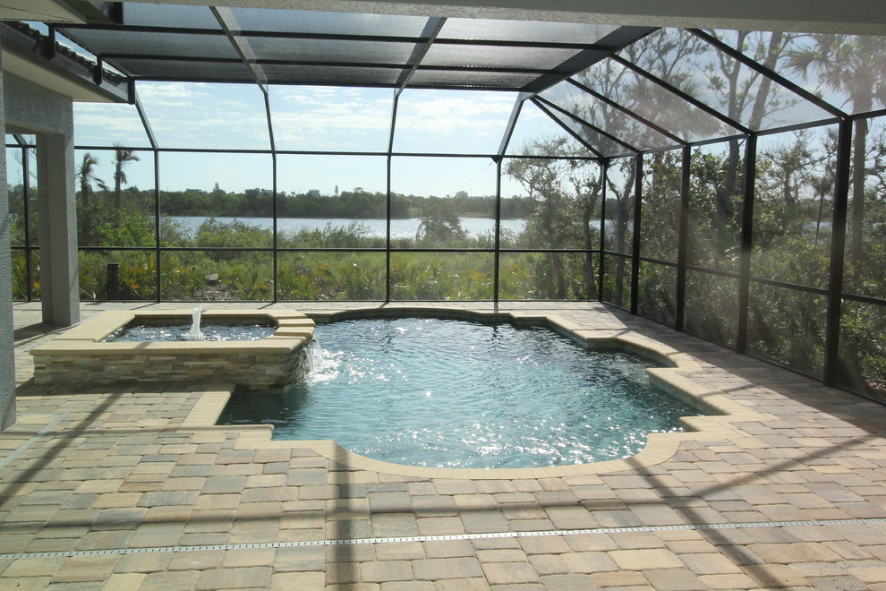 Design ideas for a large mediterranean indoor custom shaped lengths hot tub in Orlando with concrete paving.