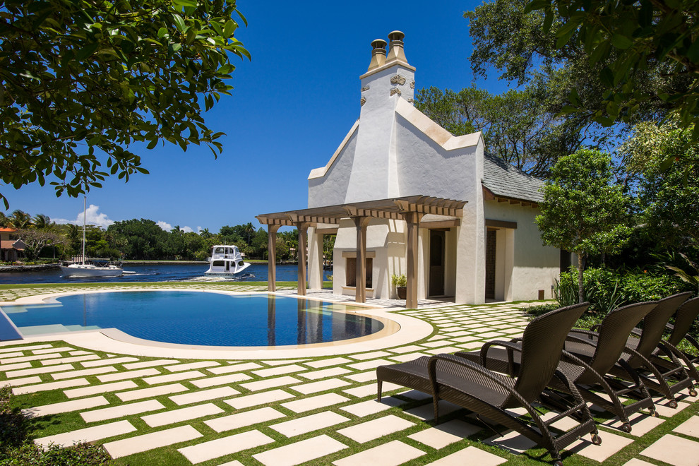 This is an example of an expansive traditional custom shaped swimming pool in Miami.