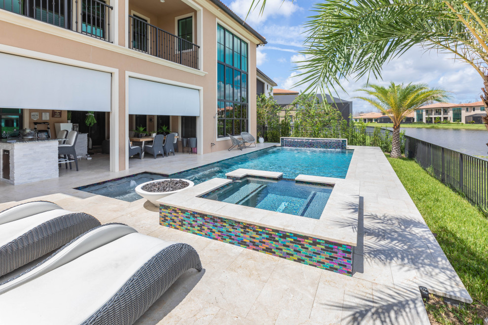 Hot tub - mid-sized tropical backyard stone and rectangular lap hot tub idea in Miami