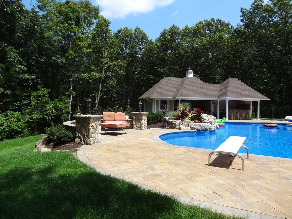 Foto de casa de la piscina y piscina clásica renovada grande a medida en patio trasero con adoquines de piedra natural