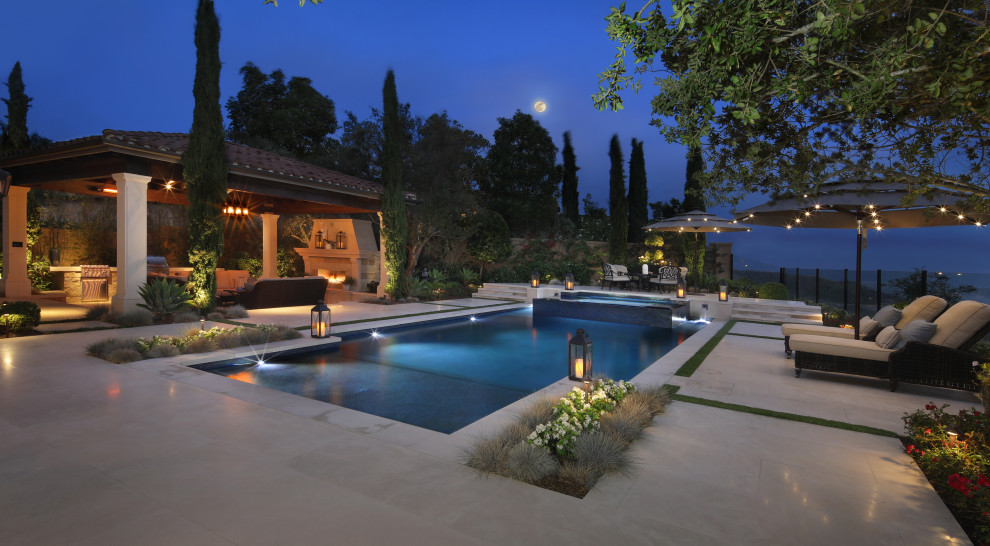 Immagine di una grande piscina minimal rettangolare dietro casa con una vasca idromassaggio e pavimentazioni in pietra naturale