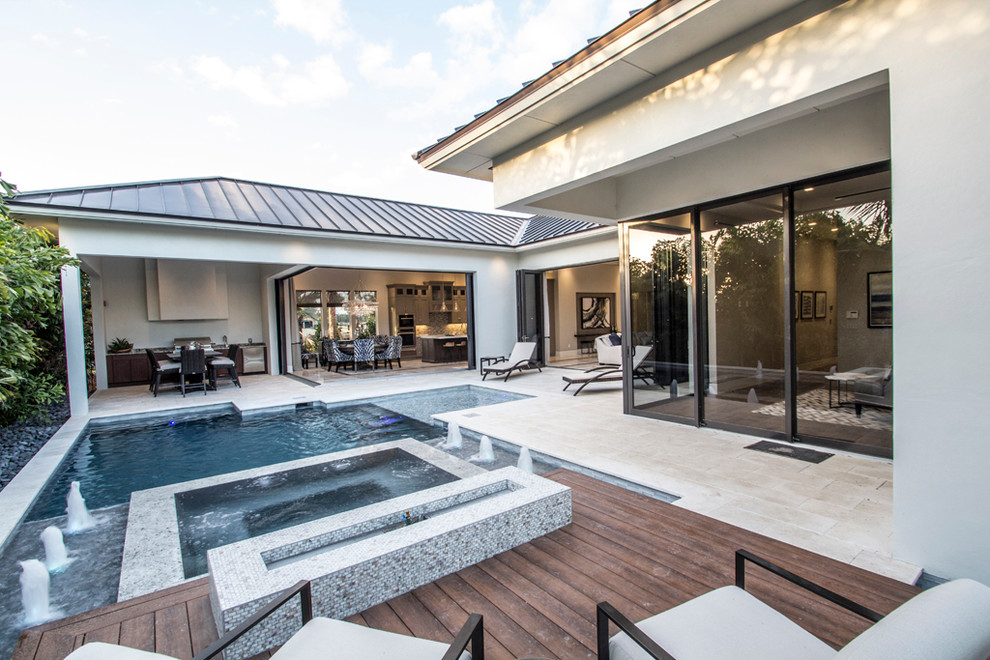 Hot tub - large modern backyard custom-shaped and tile lap hot tub idea in Miami