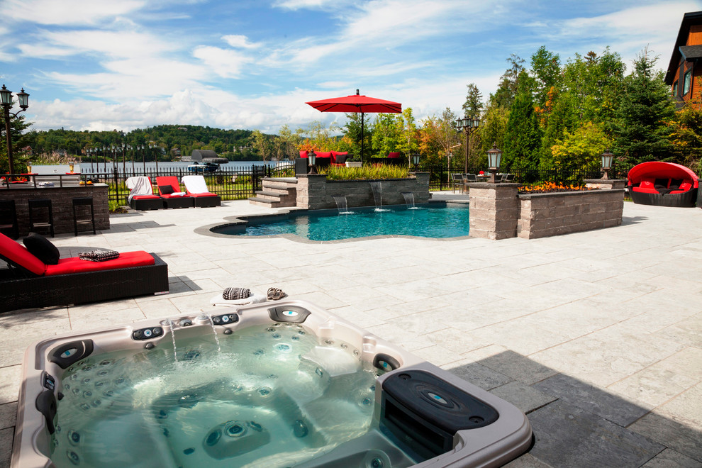 Inspiration for a timeless backyard stone and custom-shaped lap pool fountain remodel in Montreal