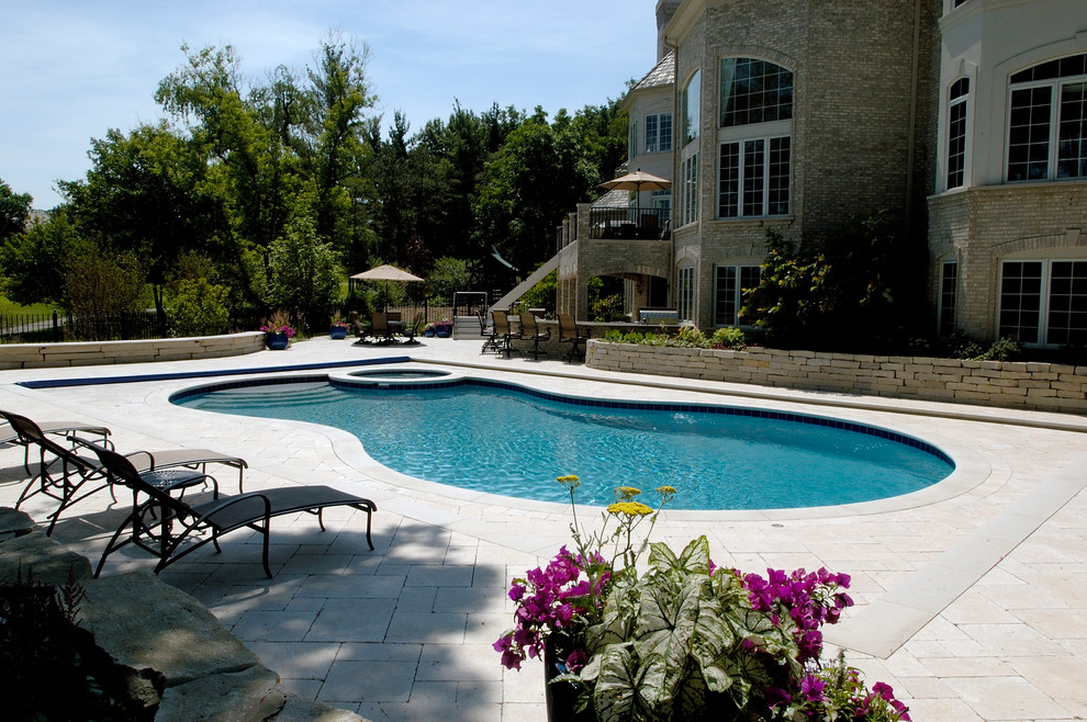 Inspiration for a huge timeless backyard stone and custom-shaped natural hot tub remodel in Chicago